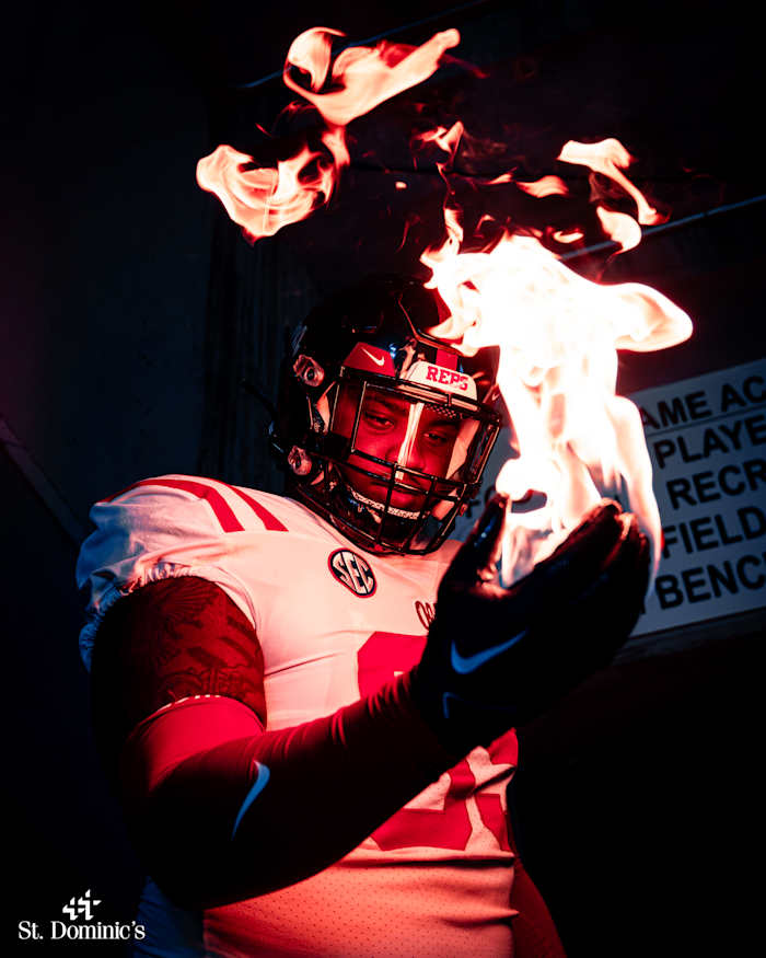 Ole Miss defensive lineman J.J. Pegues models the Rebels' uniform choice as they prepare to take on his former team on Saturday night.
